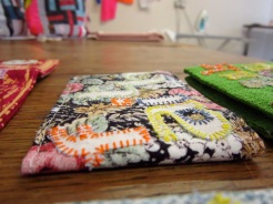 Hand and machine stitched cloth oyster card wallets using affirmations, fonts,art, applique and multi colour thread and fabric.